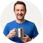 Total Branded employee David holding the Alps Insulated Mug with Carabiner